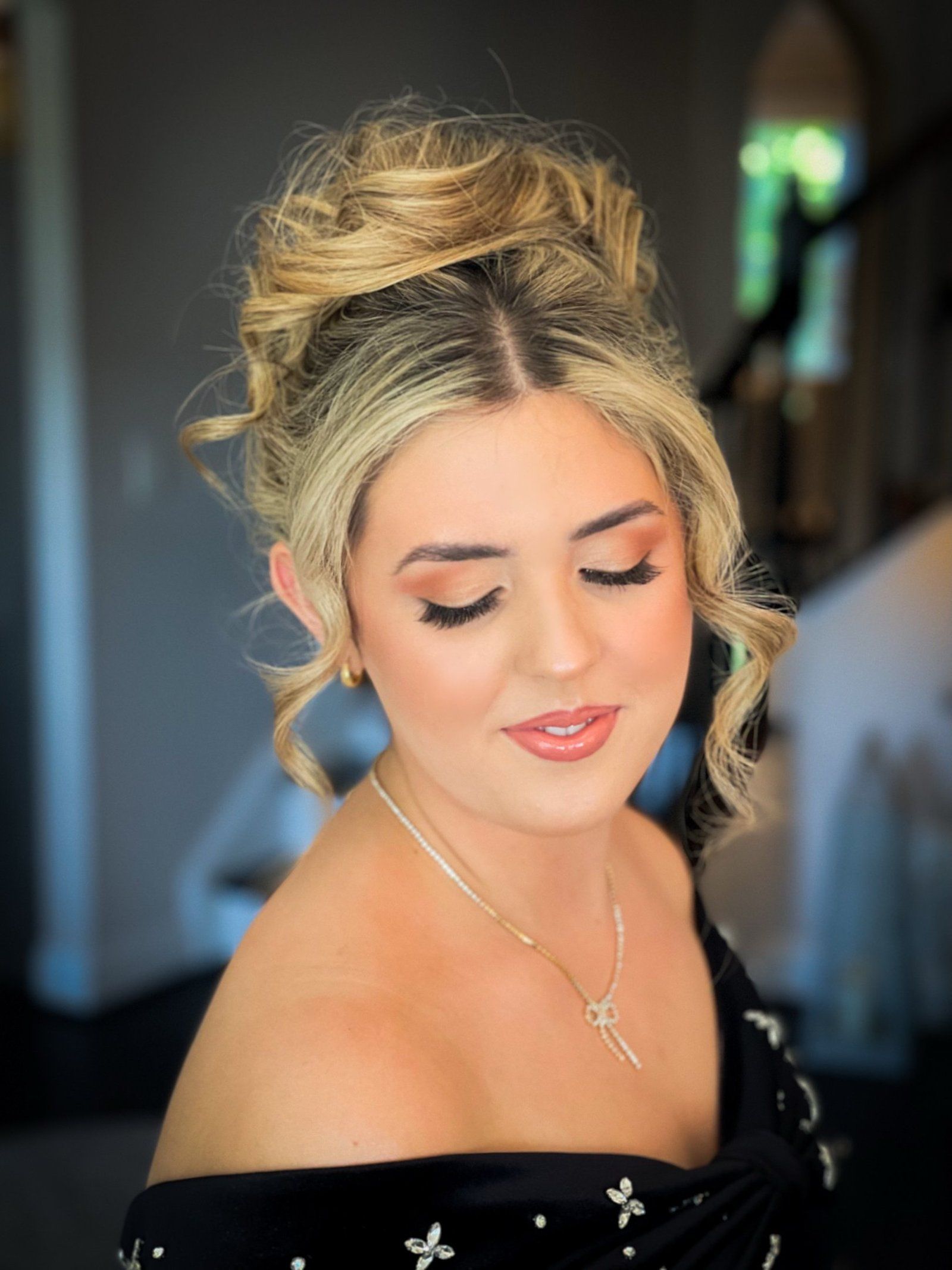A makeup artist applying airbrush foundation in fine, even veils